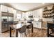 Modern kitchen featuring stainless steel appliances, white cabinetry, and a cozy dining area at 1603 E Market St, Indianapolis, IN 46201