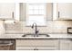 Close up of the spacious kitchen, featuring stainless steel sink and modern backsplash at 1603 E Market St, Indianapolis, IN 46201