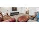 Carpeted living room features leather couch, a gray fabric couch, TV and console, and an ottoman at 1603 E Market St, Indianapolis, IN 46201