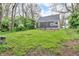 Lush backyard with mature trees and a spacious lawn perfect for outdoor activities and relaxation at 1621 E 44Th St, Indianapolis, IN 46205