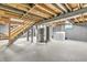 Unfinished basement featuring a staircase, laundry area, exposed beams, and concrete flooring at 1621 E 44Th St, Indianapolis, IN 46205