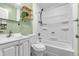 Bathroom with green walls, modern vanity, decorative shelving, and shower over tub at 1621 E 44Th St, Indianapolis, IN 46205