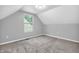 Bedroom features carpeted flooring, gray walls, and a large window for natural light at 1621 E 44Th St, Indianapolis, IN 46205