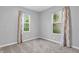 Bright bedroom featuring gray walls, plush carpet and two windows dressed with stylish curtains at 1621 E 44Th St, Indianapolis, IN 46205