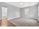 Bedroom with carpet and ensuite bathroom, featuring neutral tones and a window at 1621 E 44Th St, Indianapolis, IN 46205