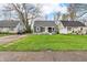 Charming home with a well-manicured front lawn and a welcoming porch, showcasing curb appeal at 1621 E 44Th St, Indianapolis, IN 46205