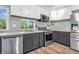 Bright kitchen with stainless steel appliances, wood floors and gray cabinets at 1621 E 44Th St, Indianapolis, IN 46205