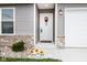 Close-up of the home's inviting front door with wreath and attractive exterior lighting at 1631 W Paula Dr, Columbus, IN 47201