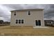View of a two-story house with sliding glass doors and a spacious backyard, perfect for outdoor activities and relaxation at 17026 Cowbell Dr, Noblesville, IN 46060