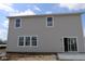 The backyard has newly installed siding, with a sliding glass door leading to the patio at 17026 Cowbell Dr, Noblesville, IN 46060