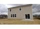 New two-story home with a sliding glass door to the concrete patio and grass backyard at 17026 Cowbell Dr, Noblesville, IN 46060