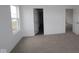 Bedroom with neutral carpet, a window for natural light, and closet and hallway access at 17026 Cowbell Dr, Noblesville, IN 46060