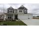 Two-story home featuring a two-car garage, covered porch, and neutral color palette at 17026 Cowbell Dr, Noblesville, IN 46060