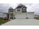 Two-story home featuring a two-car garage, covered porch, and neutral color palette at 17026 Cowbell Dr, Noblesville, IN 46060