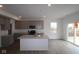 Bright kitchen featuring an island, stainless appliances, light gray cabinets, and hardwood floors at 17026 Cowbell Dr, Noblesville, IN 46060