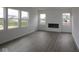 Bright living room featuring hardwood floors, many windows, and an electric fireplace at 17026 Cowbell Dr, Noblesville, IN 46060