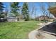 Spacious backyard featuring a storage shed, firepit, and patio area with plenty of green space at 1750 W Stop 11 Rd, Indianapolis, IN 46217
