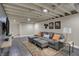 Comfortable finished basement living space with a sectional, ottomans, and decorative rug at 1750 W Stop 11 Rd, Indianapolis, IN 46217
