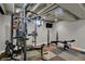 Finished basement gym area equipped with a weight machine and exercise bench at 1750 W Stop 11 Rd, Indianapolis, IN 46217