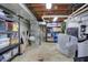 Unfinished basement with exposed utilities, shelving, and storage space at 1750 W Stop 11 Rd, Indianapolis, IN 46217