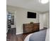 Bedroom features a walk-in closet, dresser, and wood flooring at 1750 W Stop 11 Rd, Indianapolis, IN 46217