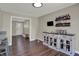 Open dining area with breakfast bar featuring custom cabinetry, hardwood floors, and door to yard at 1750 W Stop 11 Rd, Indianapolis, IN 46217
