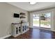 Dining area with sliding glass doors to backyard, custom built-in cabinetry, and hardwood floors at 1750 W Stop 11 Rd, Indianapolis, IN 46217