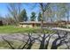 Charming single-story home featuring a stone facade, manicured lawn, and mature trees providing ample shade at 1750 W Stop 11 Rd, Indianapolis, IN 46217