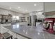 This remodeled kitchen features gray countertops, white cabinets, stainless appliances, and a center island at 1750 W Stop 11 Rd, Indianapolis, IN 46217