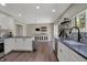 Updated open kitchen offers stainless steel appliances, gray counters, white cabinets, and backyard views at 1750 W Stop 11 Rd, Indianapolis, IN 46217