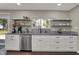 This kitchen features stainless steel appliances, gray countertops, white cabinets and backyard views at 1750 W Stop 11 Rd, Indianapolis, IN 46217