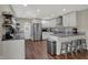 Modern kitchen features stainless steel appliances, white cabinetry, and plenty of counter space at 1750 W Stop 11 Rd, Indianapolis, IN 46217