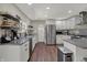Bright kitchen boasts white cabinets, stainless steel appliances, gray countertops, and stylish backsplash at 1750 W Stop 11 Rd, Indianapolis, IN 46217