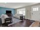Well-lit living room with plush seating, area rug, large window, and contemporary decor at 1750 W Stop 11 Rd, Indianapolis, IN 46217