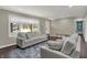 Spacious living room with hardwood floors, large windows, comfortable seating, and stylish decor at 1750 W Stop 11 Rd, Indianapolis, IN 46217