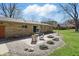 Paver patio with outdoor furniture and a built-in fire pit perfect for entertaining at 1750 W Stop 11 Rd, Indianapolis, IN 46217