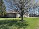 Lush green backyard featuring mature trees with a patio area, perfect for outdoor living at 18346 Piers End Dr, Noblesville, IN 46062