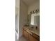 Bathroom with a wood vanity, framed mirror, vanity lighting and a doorway to the shower at 18346 Piers End Dr, Noblesville, IN 46062