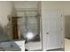 Bathroom featuring a tub and shower combination with a glass door and neutral walls at 18346 Piers End Dr, Noblesville, IN 46062