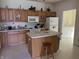 Well-lit kitchen featuring plenty of cabinets, an island, and modern appliances at 18346 Piers End Dr, Noblesville, IN 46062