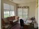 Cozy office area with woven furniture, natural light, and sliding glass doors leading outside at 18346 Piers End Dr, Noblesville, IN 46062