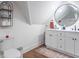 Bright bathroom with double sink vanity, round mirror, modern fixtures, and ample counter space at 1838 Applegate St, Indianapolis, IN 46203