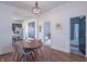 Dining area with a wooden table set, leading to a kitchen and bedroom at 1838 Applegate St, Indianapolis, IN 46203