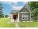 Charming two-story home featuring gray siding, well-manicured lawn, and inviting front porch at 1838 Applegate St, Indianapolis, IN 46203
