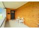Cozy front porch with wood-paneled walls, seating, and a view of the front yard at 1838 Applegate St, Indianapolis, IN 46203