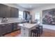 Modern kitchen featuring stainless steel appliances, an island with seating, and dark cabinetry at 1838 Applegate St, Indianapolis, IN 46203
