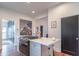 Bright kitchen featuring a modern island with white countertop and stainless steel gas range at 1838 Applegate St, Indianapolis, IN 46203