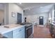 Open-concept kitchen with stainless steel appliances and island, flowing into the bright living area at 1838 Applegate St, Indianapolis, IN 46203