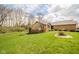 Expansive backyard with lush green lawn, landscaping, and the rear of the brick house at 206 Somerville Rd, Anderson, IN 46011