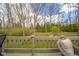 Backyard view from deck featuring lush green grass and mature trees at 206 Somerville Rd, Anderson, IN 46011